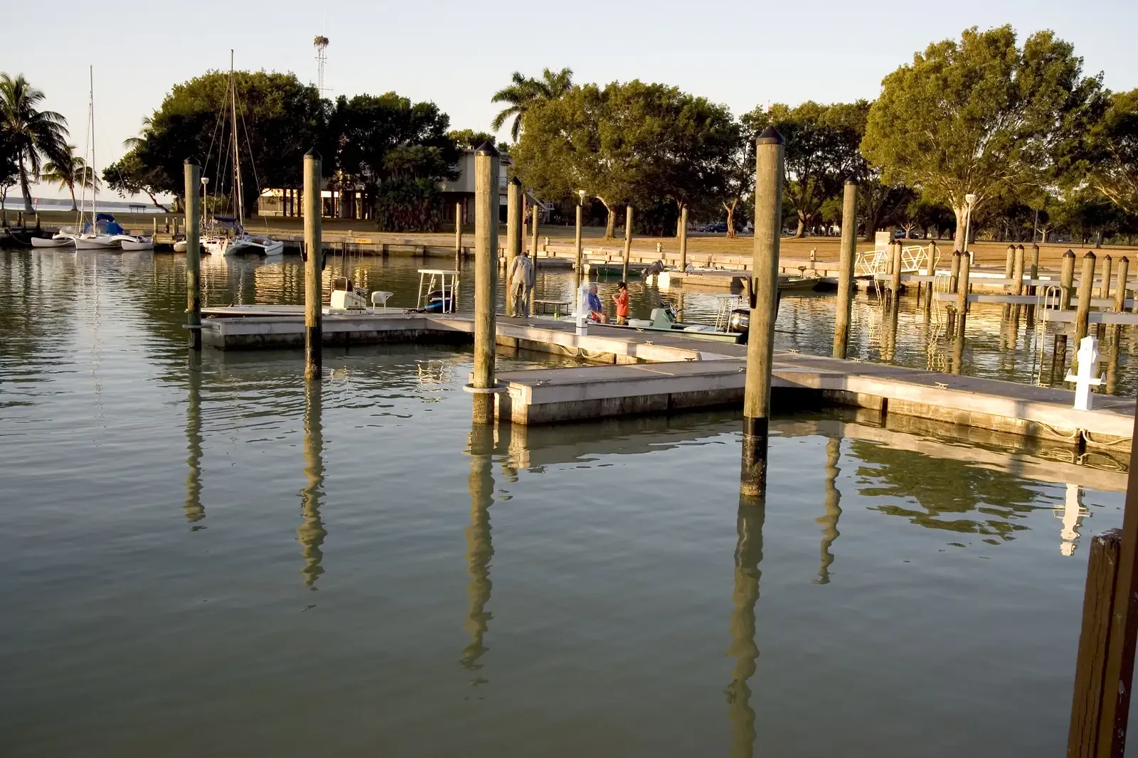 Boat docks and wooden pilings reflected in calm water at the Flamingo marina